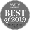 This image shows a circular badge with the text "Seattle Magazine Best of 2019 Readers' Choice Winner" in white on a gray background.